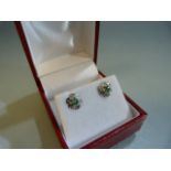 Pair of white gold emerald and diamond stud earrings