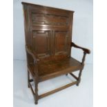 Oak single seater Antique settle with carved decoration to a tall back.