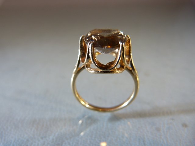 9ct Gold ring with high setting supporting a large Citrine