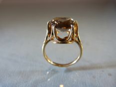 9ct Gold ring with high setting supporting a large Citrine