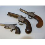 Three muff style pistols all with wooden handles (two percussion) the smallest marked 274