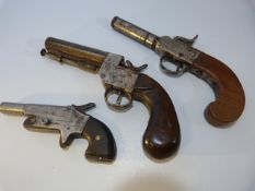 Three muff style pistols all with wooden handles (two percussion) the smallest marked 274