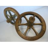 Two small vintage oak and metal bound cart wheels