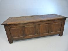 Antique oak coffer with carved panels