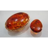 Baltic Amber brooch approx 30mm x 44mm wide with a yellow metal surround and pin. Together with a