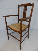 Antique turned wooden chair with stick stretchers and open arms