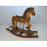 Folk Art wooden rocking horse with painted saddle and horse hair tail. Originally on cast iron