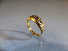 18ct GOLD ring set with graduated Sapphire stones in a oval setting. Size O