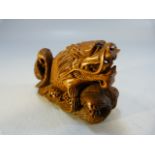 Carved wooden Netsuke of a dragon among water