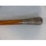 Walking cane - possibly Maple/Walnut mounted with silver coloured metal top of Rococo scrolls and