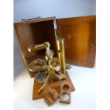 MICROSCOPE - Unmarked brass microscope mounted onto wooden plinth for fitted case. Fitted case