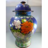 A very large Chinese cloisonne jar depicting chrysanthemums and flowers on a dark blue background (