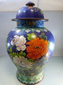 A very large Chinese cloisonne jar depicting chrysanthemums and flowers on a dark blue background (