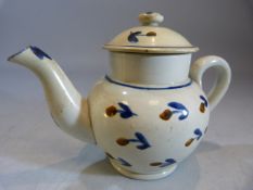 Miniature Creamware Pratt Teapot and cover. Decorated with blue and ochre in the form of flowers