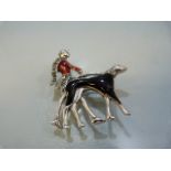 Silver art-deco style enamel-set brooch of a lady walking her dog