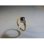 9ct Gold (London 1989) Sapphire and Diamond 3 stone Trilogy Ring. The centre oval Sapphire is