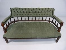 Early Victorian mahogany sofa with turned wooden Galleried back and later upholstery.