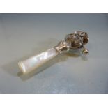 Silver baby's rattle in the form of a lady with bonnet, with MOP handle