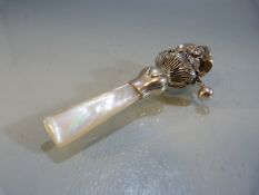 Silver baby's rattle in the form of a lady with bonnet, with MOP handle