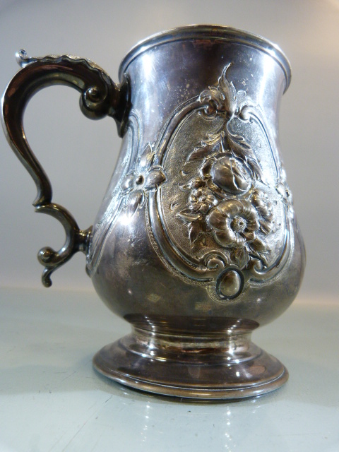 Victorian Silver tankard of Baluster form with embossed flowers and foliate scrolls flanking a