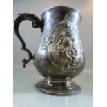 Victorian Silver tankard of Baluster form with embossed flowers and foliate scrolls flanking a