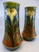 Pair of Art Nouveau Stoneware vases with single flower to front. Decorated in a drip glaze