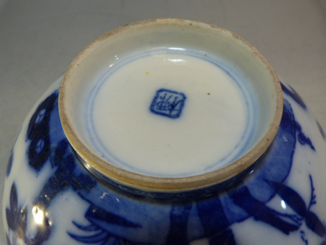 A Chinese bowl decorated in Blue and White with flowers and a two men in a sailing boat with a - Image 11 of 13