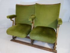 Pair of Folding 20th century cinema theatre seats with cast iron ends and green velour upholstery.