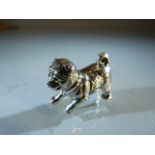 Silver figure of a puppy with glass eyes