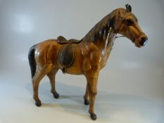 Antique carved wooden leather clad figure of a horse