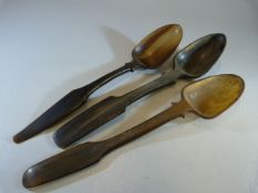 Three similar carved horn spoons with triangular bowls