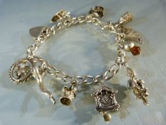 Silver Charm bracelet with ten charms and hallmarked Lock