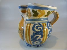 Italian Faience pottery drug jar with pinched spout. Decorated in Ochre Blue and black. Marked