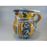 Italian Faience pottery drug jar with pinched spout. Decorated in Ochre Blue and black. Marked