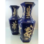 A Pair of Chinese Blue and White Hexagonal vases with depictions of dragons created with raised