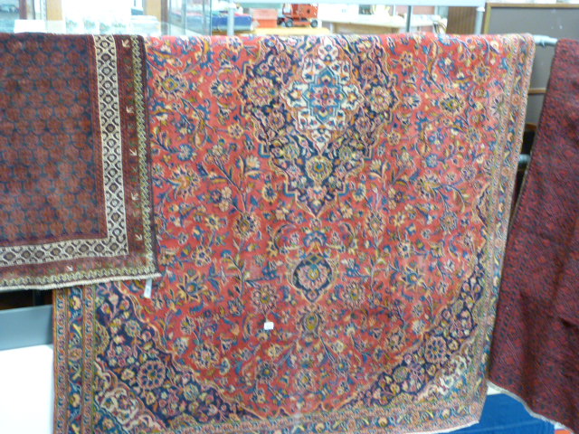 Large red ground carpet with all over pattern 2.1 x 2.7