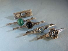 Five Vintage silver brooches each set with polished stones