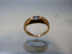 18ct Gold ring with central Sapphire and Diamonds to shoulders all set in star settings