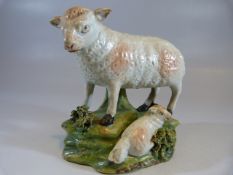 Early 19th Century staffordshire sheep and recumbent lamb on naturalistic base.