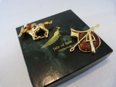 Two Gold coloured racing brooches with enamel.