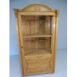 Antique pine glazed cabinet with single opening door. Fitted interior with raised shelf on