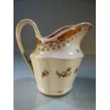 Antique staffordshire jug decorated with a spray of flowers to one side and a high beak.