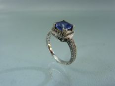 18ct White Gold and Tanzanite set ring. Large central Tanzanite surround and flanked to shoulders by