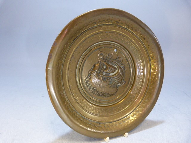 Brass hammered pin dish with central panel depicting a clipper ship at sea.