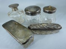 Five hallmarked silver dressing table jars of different sizes.