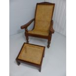 A 20th Century Plantation/Bergere chair with a slide out arms