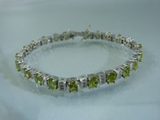 Silver 925 Tennis style Bracelet set with Peridot. Apprx 19.5cm.