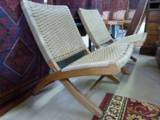 Pair of Folding teak and wicker upholstered recliner chairs