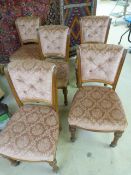 Set of five Victorian upholstered dining chairs with scroll backs on pilaster legs