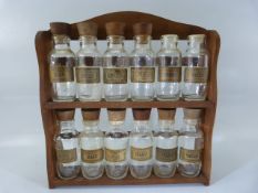 Set of glass and wooden topped spice jars with rack. (2 missing lids) (12 bottles in total)